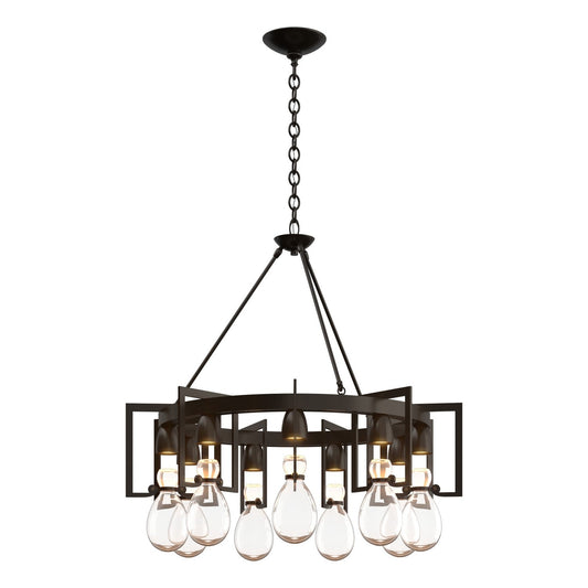 Hubbardton Forge Apothecary Nine Light Chandelier with black metal frame and clear glass shades hanging from a ceiling mount